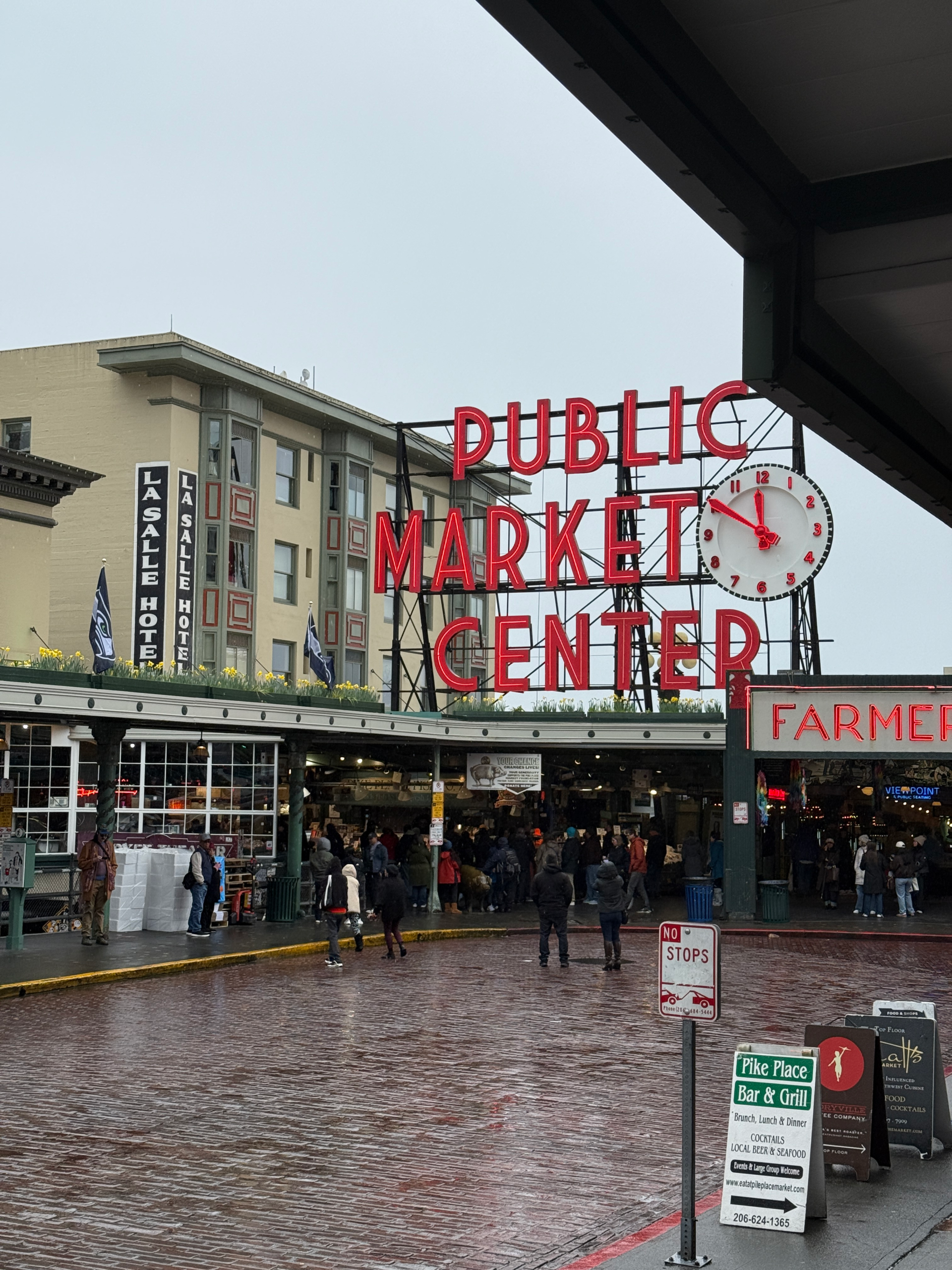 seattle pike place market sign in the rain